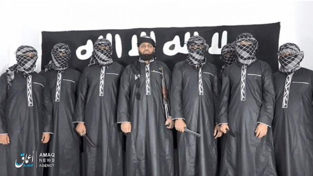An undated image posted by the ISIS "news agency" Amaq on April 23, 2019, claiming to show eight suicide bombers who carried out the Easter Sunday attacks in Sri Lanka. All have their faces obscured except for Mouvli Zahran Hasim in the middle. Fatima Ibrahim was said to be the one standing behind the men. (Amaq News Agency)