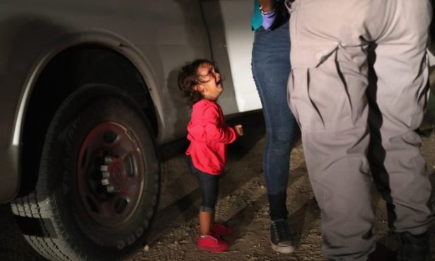 A two-year-old Honduran asylum seeker cries as her mother is searched and detained near the U.S.-Mexico border in McAllen, Texas, on June 12, 2018. (John Moore/Getty Images)