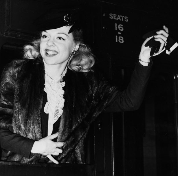 Actress Barbara Perry waving a glove