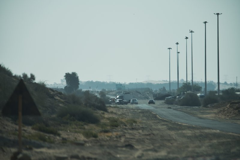 Police, ambulances and crash-site investigation vehicles are seen near the site of a small plane crash in Dubai, United Arab Emirates on May 17, 2019. (Jon Gambrell/Photo via AP)
