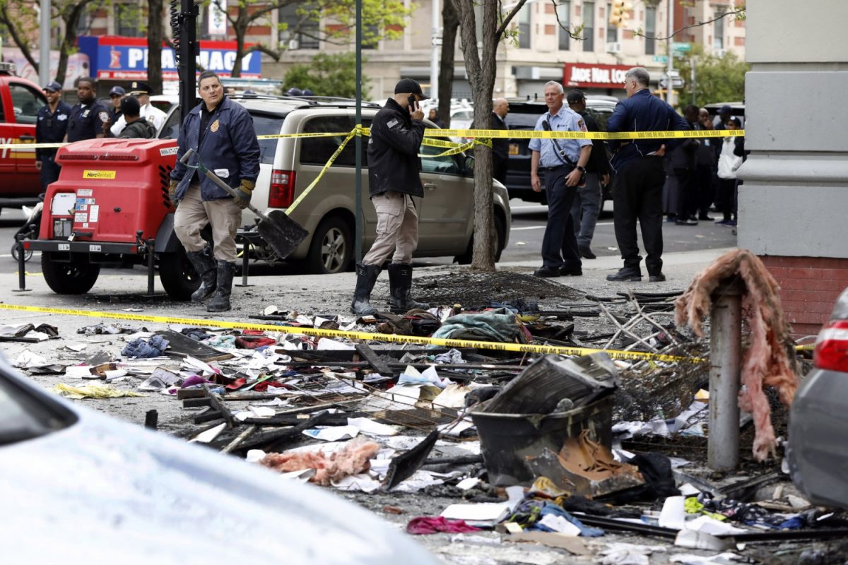 Members of the New York Fire Department work near debris from a fire in New York's Harlem neighborhood on May 8, 2019. (Richard Drew/Photo via AP)