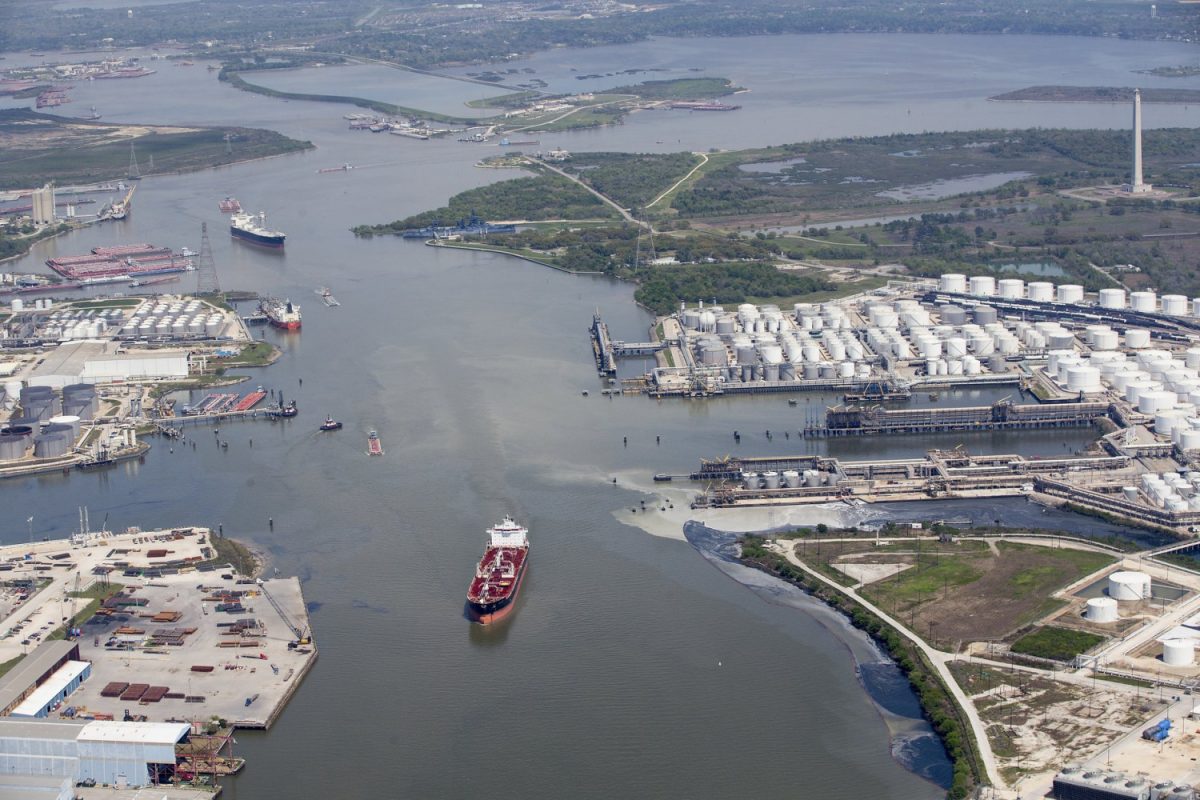 Maritime traffic moves through the Houston Ship Chanel past the site of now-extinguished petrochemical tank fire at Intercontinental Terminals Company in Deer Park, Texas, on March 20, 2019. (Brett Coomer/Houston Chronicle via AP)
