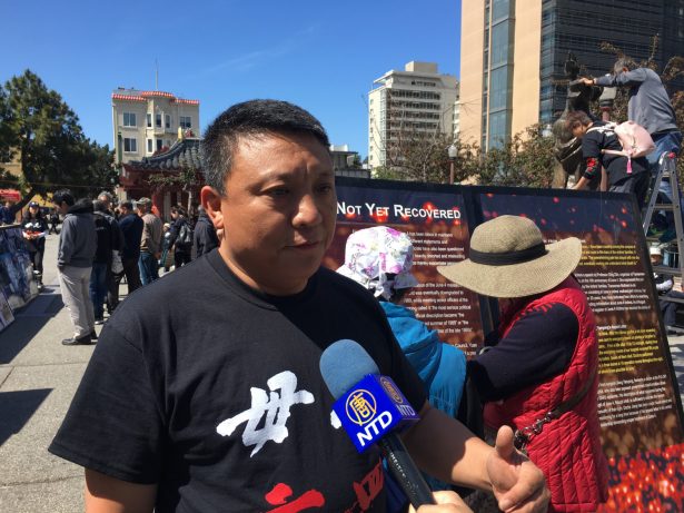 Jian Liu displayed some of his 2,000 photos for the pubic to see in San Francisco Chinatown on May 27, 2019. (Ilene Eng/NTD)