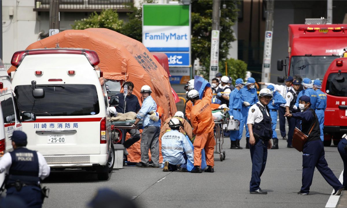 Rescue workers and police officers operate at the site where sixteen people were injured in a suspected stabbing by a man, in Kawasaki, Japan on May 28, 2019. (Kyodo/via Reuters)