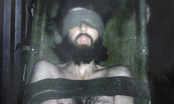 John Walker Lindh, blindfolded, strapped to a stretcher during interrogation by the US forces.