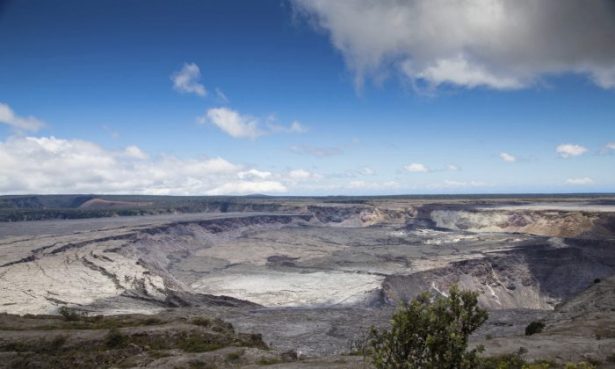 This National Park Service photo shows Halemaumau Crater, which has quadrupled in size since May, and Kilauea Caldera at Kilauea volcano's summit inside Hawaii Volcanoes National Park in Hawaii on Friday, Aug. 17, 2018. (Janice Wei/National Park Service via AP)