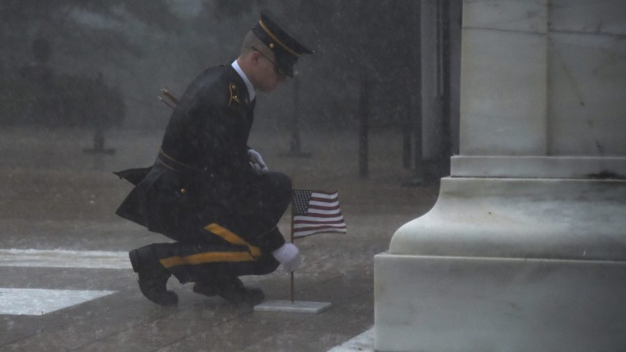 Soldier Braves Torrential Rain to Honor Fallen Comrades