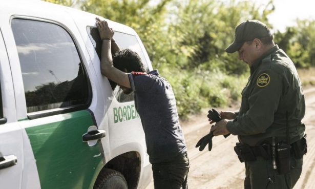 A Border Patrol agent prepares to search an illegal alien from Mexico who tried to evade capture after crossing the Rio Grande into the United States near McAllen, Texas, on April 18, 2019. (Charlotte Cuthbertson/The Epoch Times)