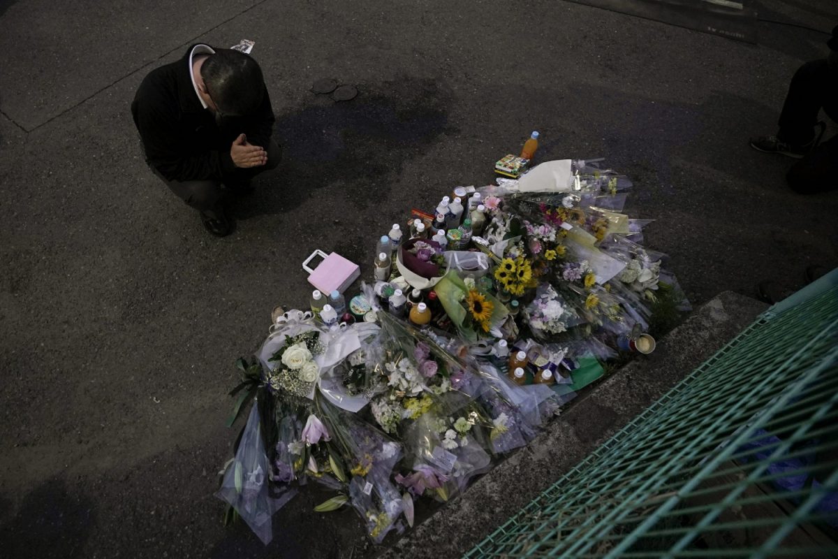A man pays respects at a makeshift memorial for the victims of a knife attack in Kawasaki, just outside Tokyo on May 28, 2019. (Jae C. Hong/Photo via AP)
