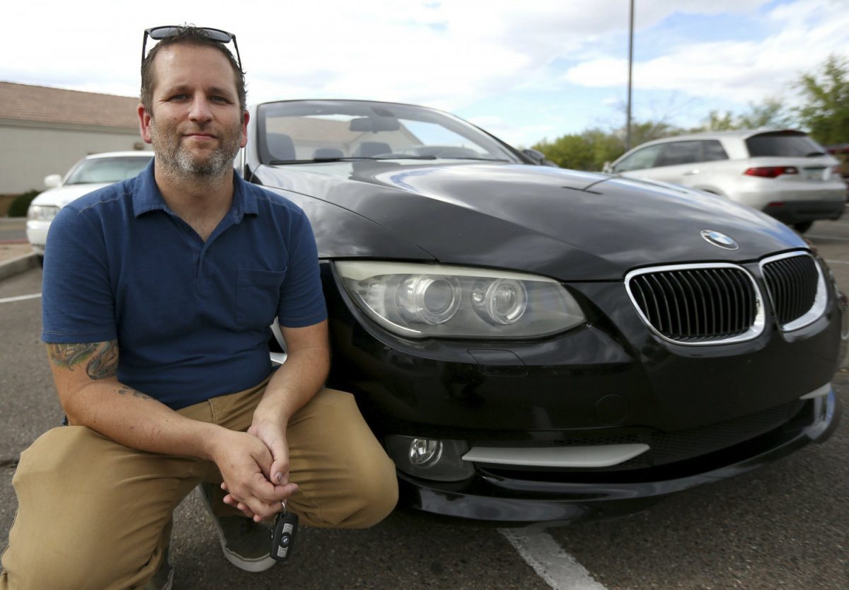 Chris Williamson poses for a photo sitting next to his car in Phoenix, Ariz., on April 23, 2019. (Ross D. Franklin/AP Photo)