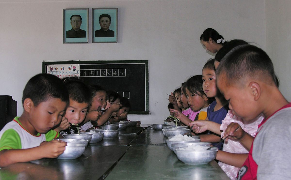 North Korean children eat lunch at a government run kindergarten at Taedong county in North Korea on July 18, 2005. (Gerald Bourke/World Food Programme via Getty Images)