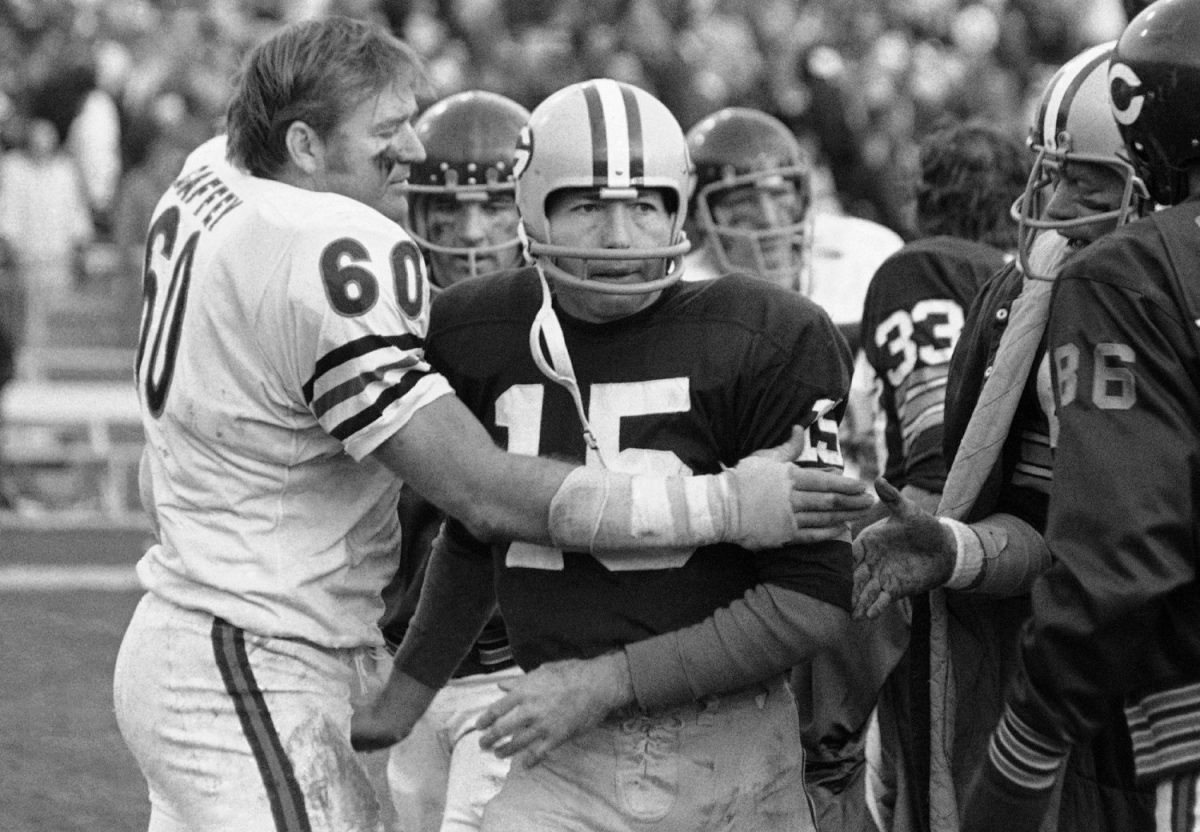 Chicago Bears' Lee Roy Caffey (60) congratulates Green Bay Packers quarterback Bart Starr after Starr scored the winning touchdown at a football game in Green Bay, Wisc. (PJS/AP Photo)