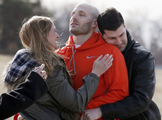 Michael Behenna (C), is embraced by his brother Brett and girlfriend Shannon Wahl following his release from prison in Leavenworth, Kan., on March 14, 2014. (Sarah Phipps/The Oklahoman via AP, File)