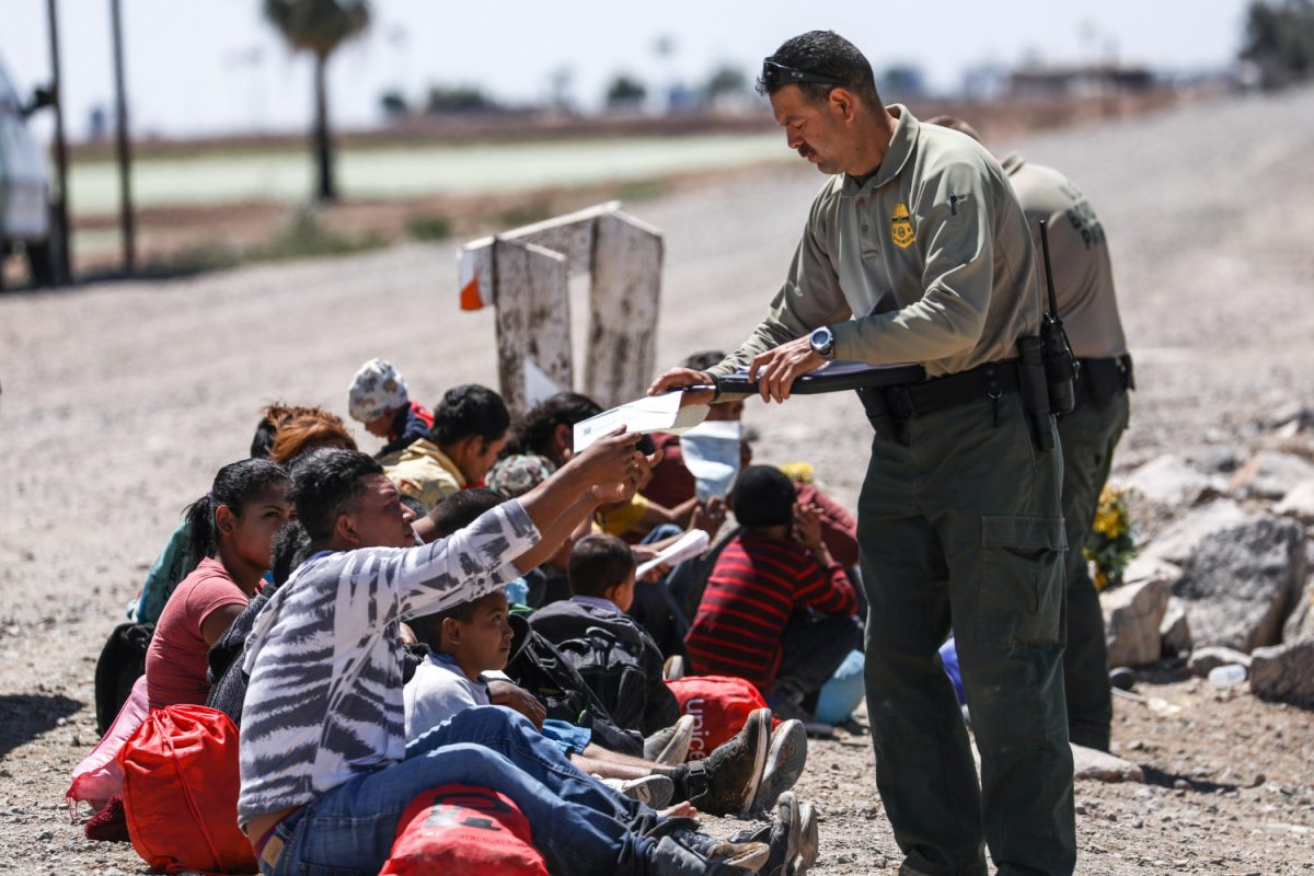 A group of illegal aliens is processed by Border Patrol agents after crossing from Mexico into Yuma, Ariz., on April 13, 2019. (Charlotte Cuthbertson/The Epoch Times)