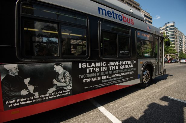 An advertisement on a bus in Washington in 2014 includes a picture of the Grand Mufti of Jerusalem Amin Al-Husseini meeting with Adolf Hitler. (Nicholas Kamm/AFP/Getty Images)
