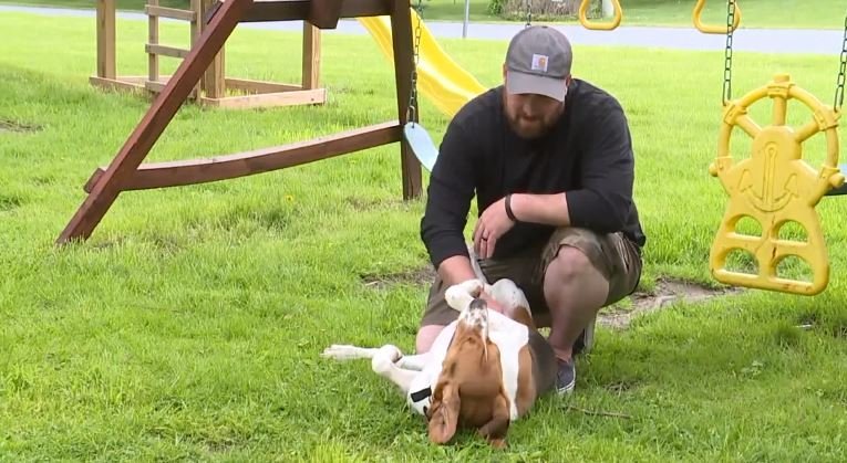 Thom Lambert plays with his rescue dog "Edgar". (WPMT via CNN)