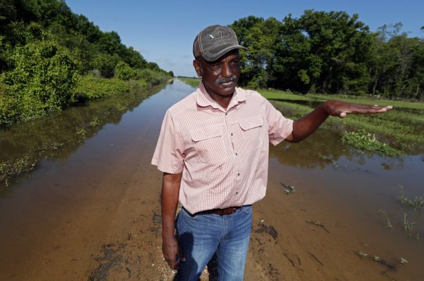 Larry Walls, a farmer and businessman stands at the edge of a backwater flooded road leading to his 560 acres of rented farm land near Louise, Miss, on May 23, 2019. (Rogelio V. Solis/AP Photo)