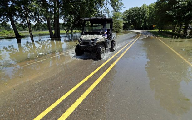 A Holly Bluff, Miss., resident drives through backwater flooded streets, on May 23, 2019. (Rogelio V. Solis/AP Photo)