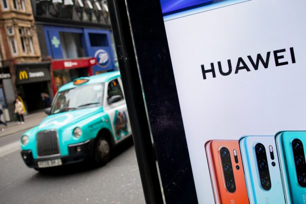 A taxi drives past a Huawei advert at a bus stop in central London, UK, on April 29, 2019. (Tolga Akmen/AFP/Getty Images)