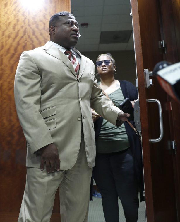 Quanell X walks out of the courtroom with Brittany Bowens, the mother of the missing 4-year-old, Meleah Davis after the court postponed a court appearance for Derion Vence, who is charged with tampering with evidence in the case of Meleah Davis' disappearance in Houston on May 13, 2019. (Karen Warren/Houston Chronicle via AP)