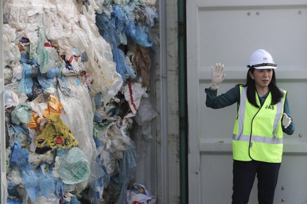 Malaysia's Minister of Energy, Science, Technology, Environment, and Climate Change Yeo Bee Yin shows plastic waste shipment in Port Klang, Malaysia, on May 28, 2019. (Vincent Thian/AP Photo)