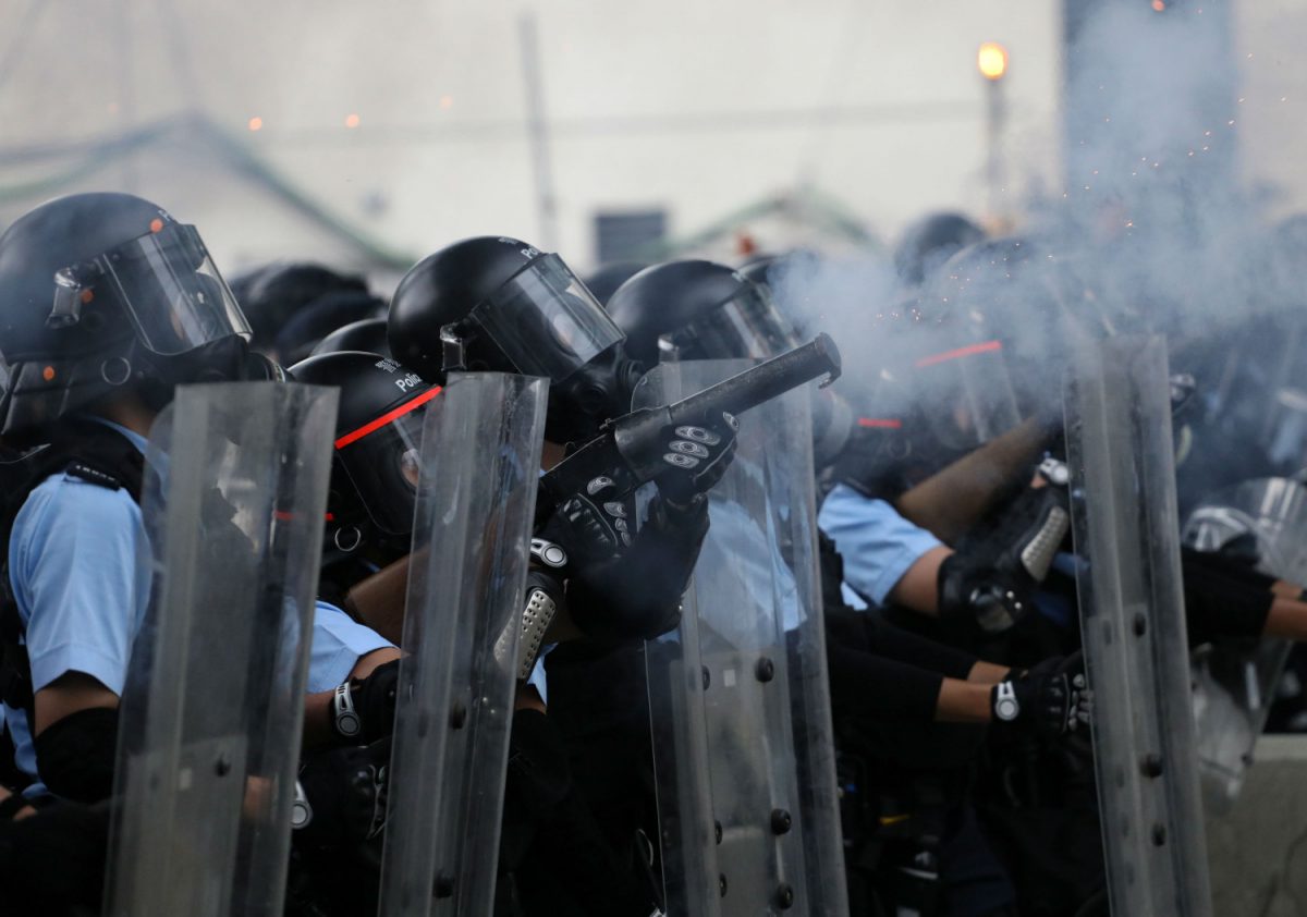 Police officer fires tear gas at protesters during a demonstration against a proposed extradition bill in Hong Kong, China June 12, 2019. (Reuters/Athit Perawongmetha)
