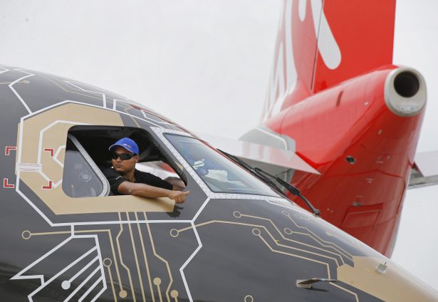A pilot of an Embraer Profit Hunter E195-E2 makes the thumbs up sign as he on the tarmac at Paris Air Show, in Le Bourget, east of Paris, France, on June 18, 2019. (Michel Euler/AP Photo)