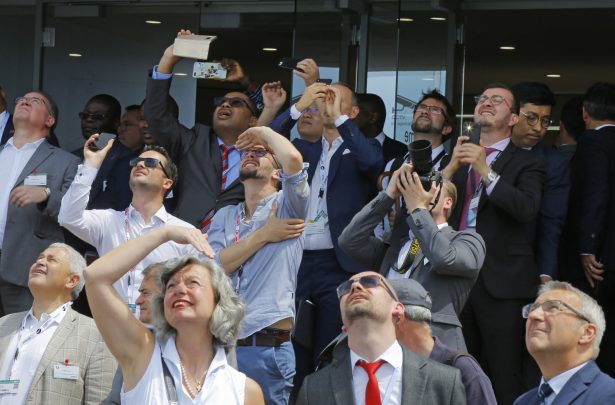 Visitors watch a demonstration flight at Paris Air Show, in Le Bourget, east of Paris, France, on June 18, 2019. (Michel Euler/AP Photo)