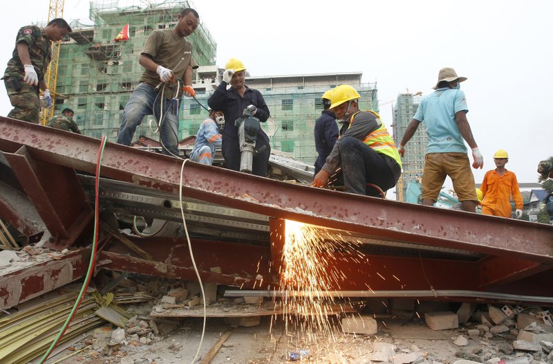 Rescue workers remove the rubble of a collapsed building in Preah Sihanouk province, Cambodia on June 22, 2019. (Heng Sinith/Photo via AP)