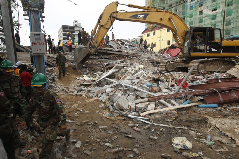 Rescuers use an excavator to remove the rubble at the site of a collapsed building in Preah Sihanouk province, Cambodia on June 22, 2019. (Heng Sinith/Photo via AP)
