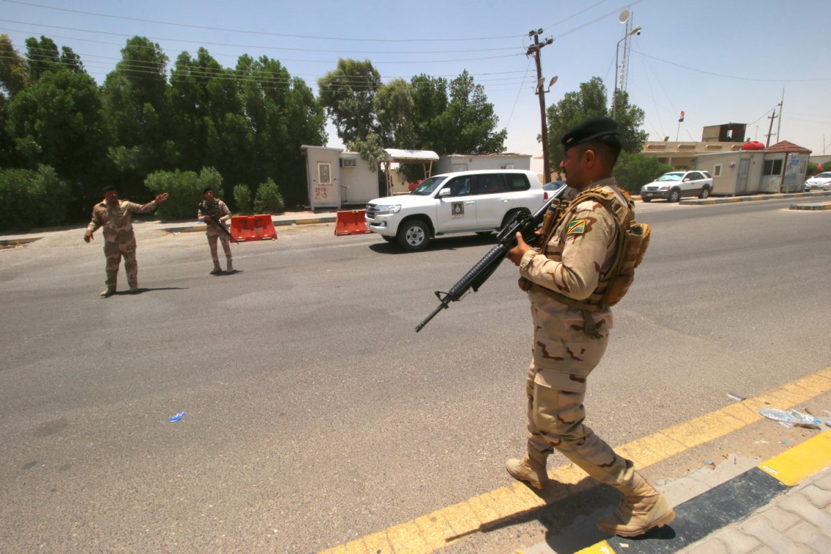 Iraqi soldiers are seen guard at the entry of Zubair oilfield after a rocket landed at a residential and operations headquarters of several oil companies, at Burjesia area in Basra, Iraq on June 19, 2019. (Essam Al-Sudani/Reuters)