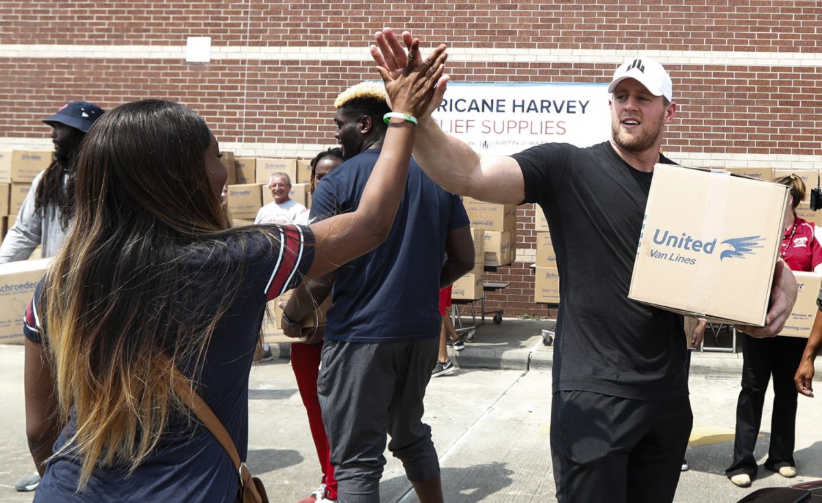 Houston Texans defensive end J.J. Watt load a car with relief supplies for people impacted by Hurricane Harvey in Houston, on Sept. 3, 2017. ( Brett Coomer/Getty Images)