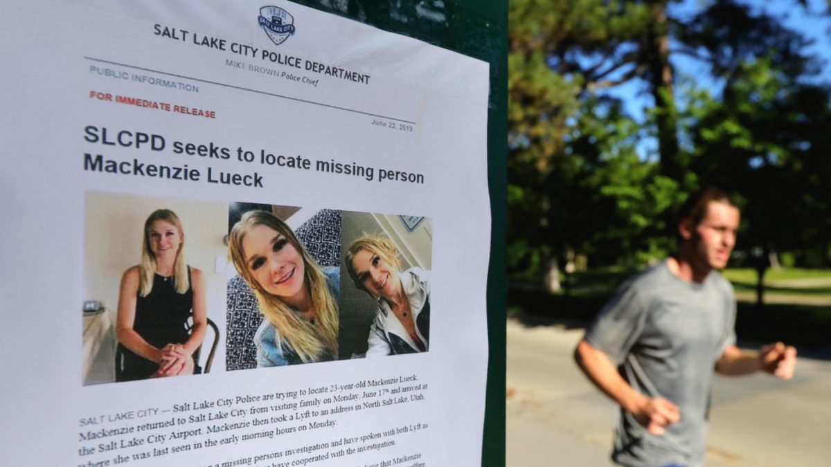 A jogger runs pass a poster of Mackenzie Lueck at Liberty Park in Salt Lake City on June 24, 2019. (Rick Bowmer/File Photo via AP)