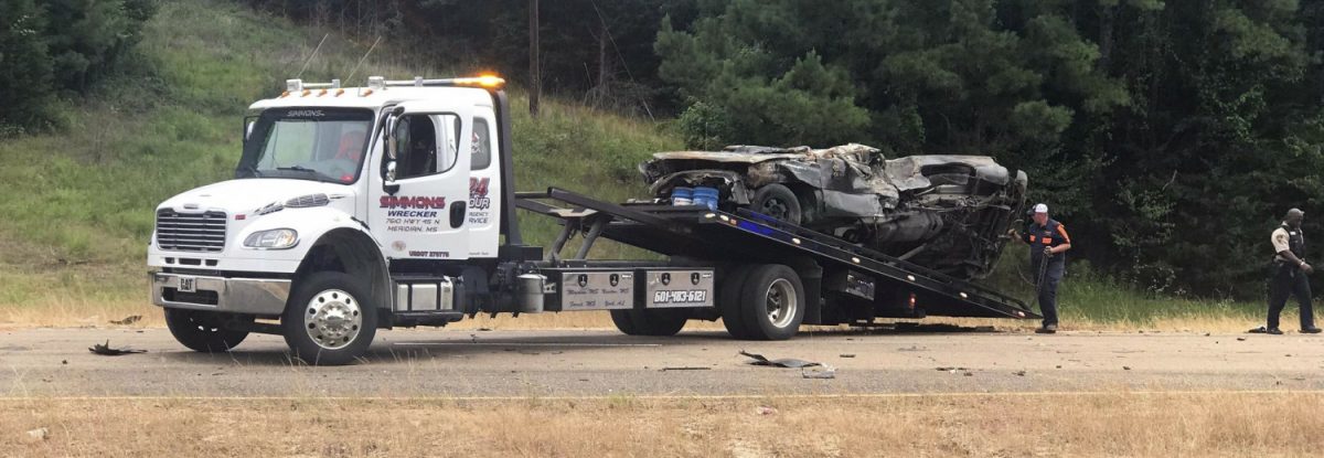 In this photo provided by The Macon Beacon, authorities remove one of several vehicles involved in a fatal crash near Scooba, Miss., on June 5, 2019. (Jeanette Unruh/The Macon Beacon via AP)