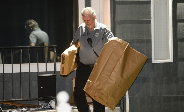 Police investigators remove multiple bags of evidence during their search of a home in Salt Lake City as part of the disappearance of University of Utah student MacKenzie Lueck that carried on into the early morning hours of June 27, 2019. (Francisco Kjolseth/The Salt Lake Tribune via AP)