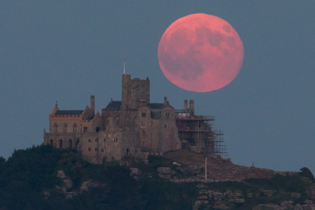 A full moon rises behind St Michael's Mount in Marazion near Penzance in Cornwall, England on June 28, 2018. (Matt Cardy/Getty Images)