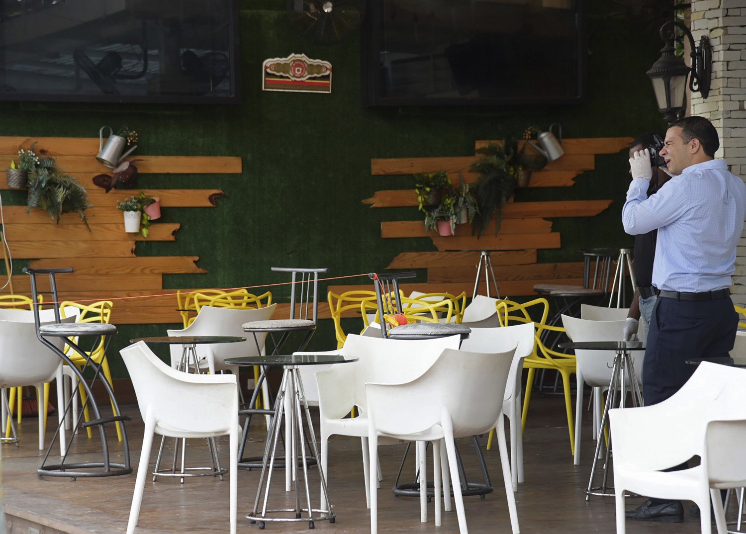 Investigative police collect evidence at the site where former Boston Red Sox slugger David Ortiz was shot the previous night inside the Dial Bar and Lounge in Santo Domingo, Dominican Republic on June 10, 2019. Dominican National Police Director Ney Aldrin Bautista Almonte said Ortiz was at the bar around 8:50 p.m. Sunday when a gunman approached from behind and shot him at close range. (AP Photo/Luis Gomez)