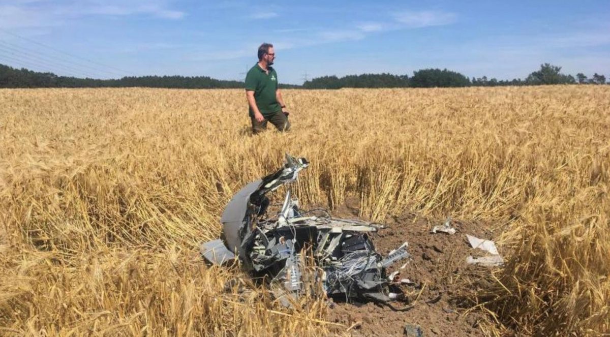 A forest official stands next to debris after two Eurofighter warplanes crashed after a mid-air collision near the village of Jabel in northeastern Germany, on June 24, 2019 (Petra Konermann/Nordkurier via Reuters)