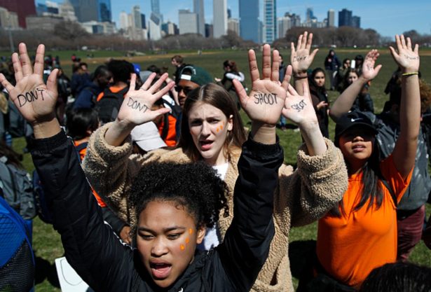 Students hold up their hands while taking part in National School Walkout Day to protest school violence in Chicago, Illi.,on April 20, 2018. (Jim Young/Getty Images)