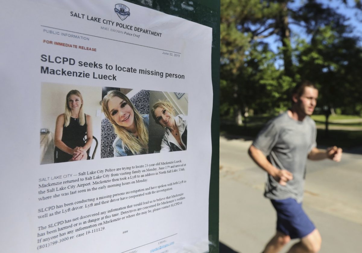 A joggers runs past a poster of Mackenzie Lueck at Liberty Park in Salt Lake City on June 24, 2019. (Rick Bowmer/AP Photo)