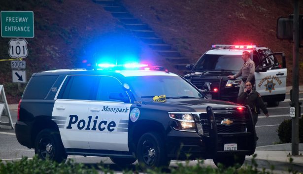 A California Highway Patrol officer mans a roadblock at a highway