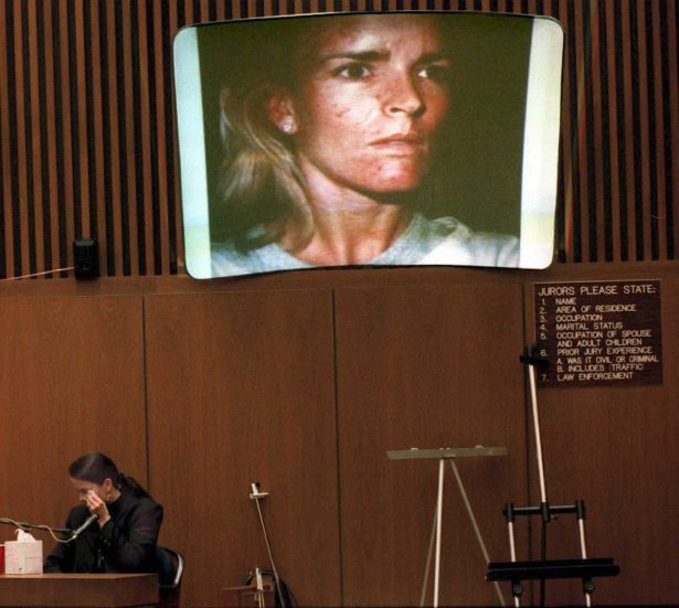 Denise Brown, the sister of murder victim Nicole Brown Simpson, cries on the witness stand on Feb. 6, 1995, as a picture she took on 01 January 1989 of a beaten Nicole is shown on a screen. (Pool/AFP/Getty Images)
