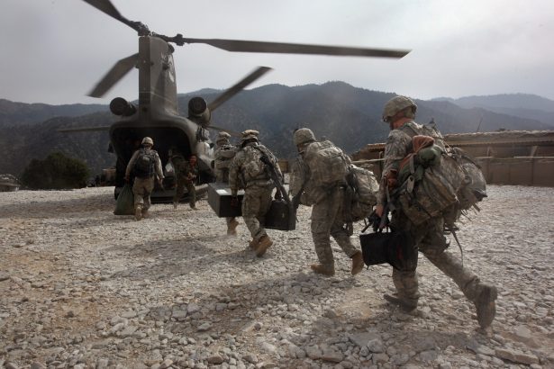 U.S. soldiers board an Army Chinook transport helicopter