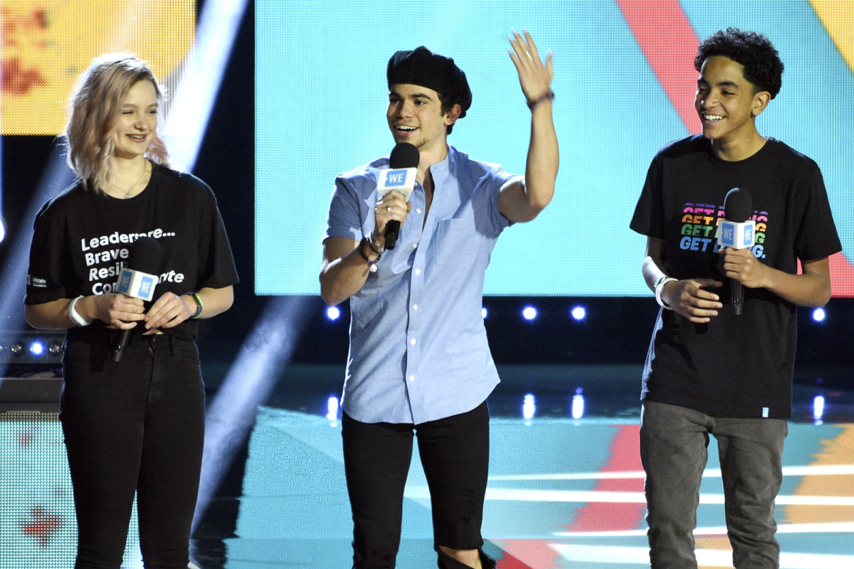 Cameron Boyce, center, speaks at WE Day California, as Macy Lillard, left, and Jazzy Satten look on at The Forum in Inglewood, Calif., on April 25, 2019. (Chris Pizzello/Invision/AP)