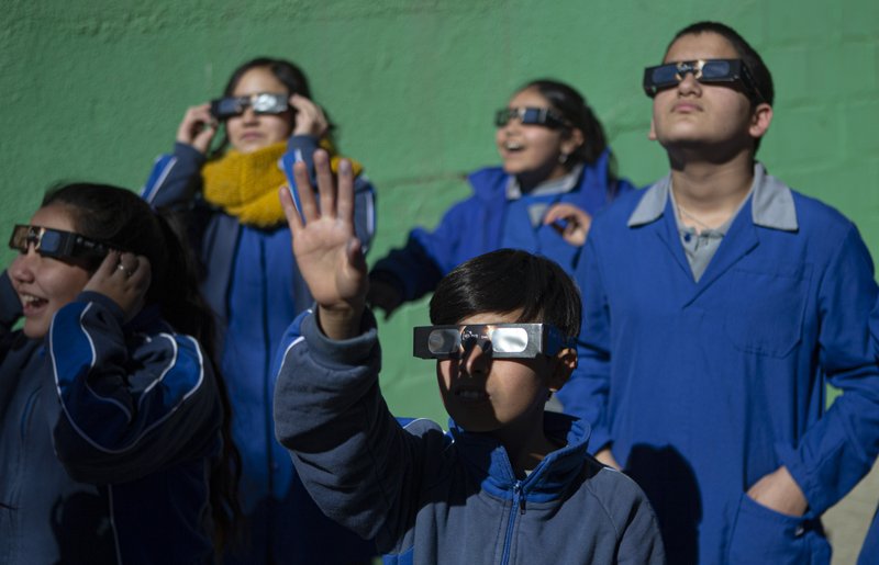 Children test on their special glasses for tomorrow's total solar eclipse at Pedro Pablo Munoz school in La Higuera, Chile on July 1, 2019. (Esteban Felix/AP)