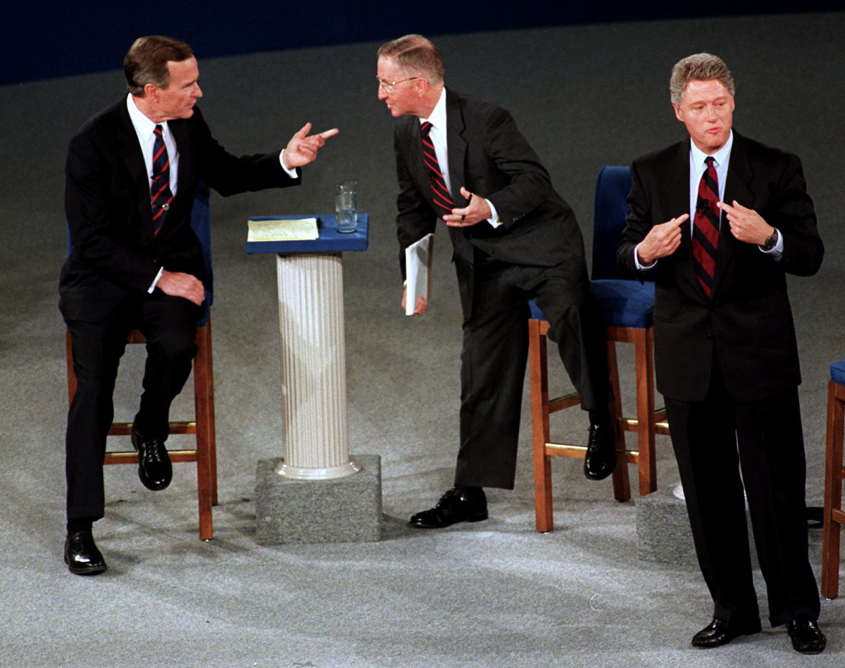 Former President George H.W. Bush, left, talks with independent candidate Ross Perot as Democratic candidate Bill Clinton stands aside at the end of their second presidential debate in Richmond, Va., on Oct. 15, 1992. (Marcy Nighswander/AP)