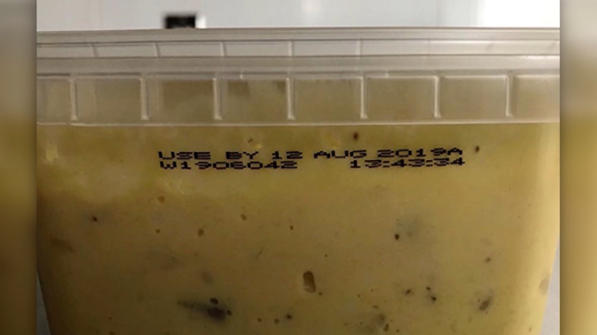 The use-by date and lot number printed on the side of the containers. (Photo Credit: FDA)