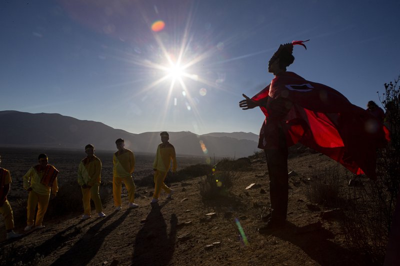 A youth dressed as a shaman arrives to take part in a photo session before Tuesday's total solar eclipse, in La Higuera, Chile on July 1, 2019. (Esteban Felix/Photo AP)