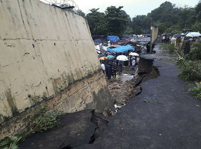 Rescuers and onlookers stand at the spot of a wall collapse in Mumbai, India on July 2, 2019. (Rafiq Maqbool/AP Photo)