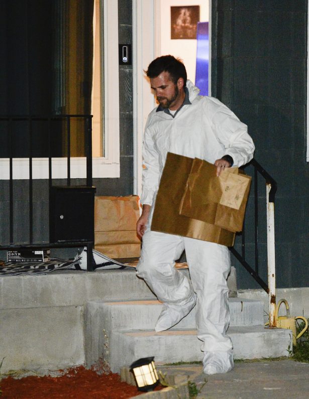 Police investigators remove multiple bags of evidence during their search of the home of Ayoola Ajayi in Salt Lake City, Utah on June 27, 2019. (Rick Bowman/AP Photo)